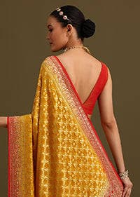 Back view of the yellow saree with the pallu over one shoulder