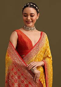 Model smiling in the yellow bandhani saree
